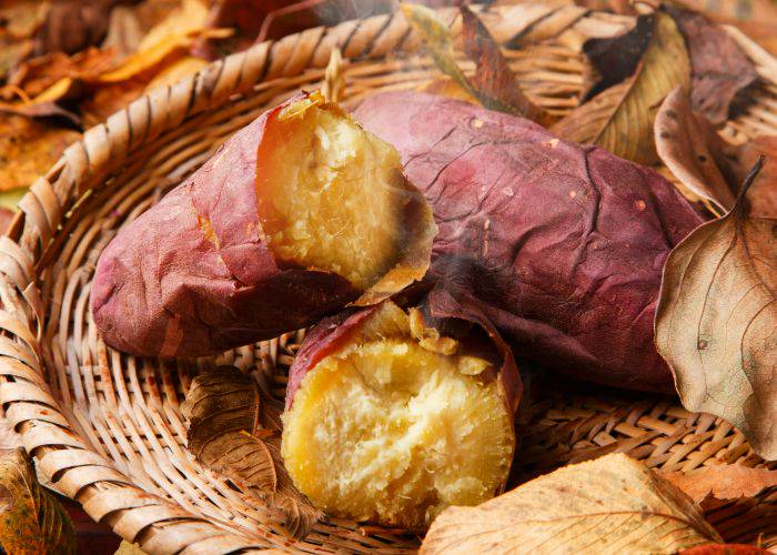 Yaki-imo sweet potatoes, baked and steaming on a wicker basket.